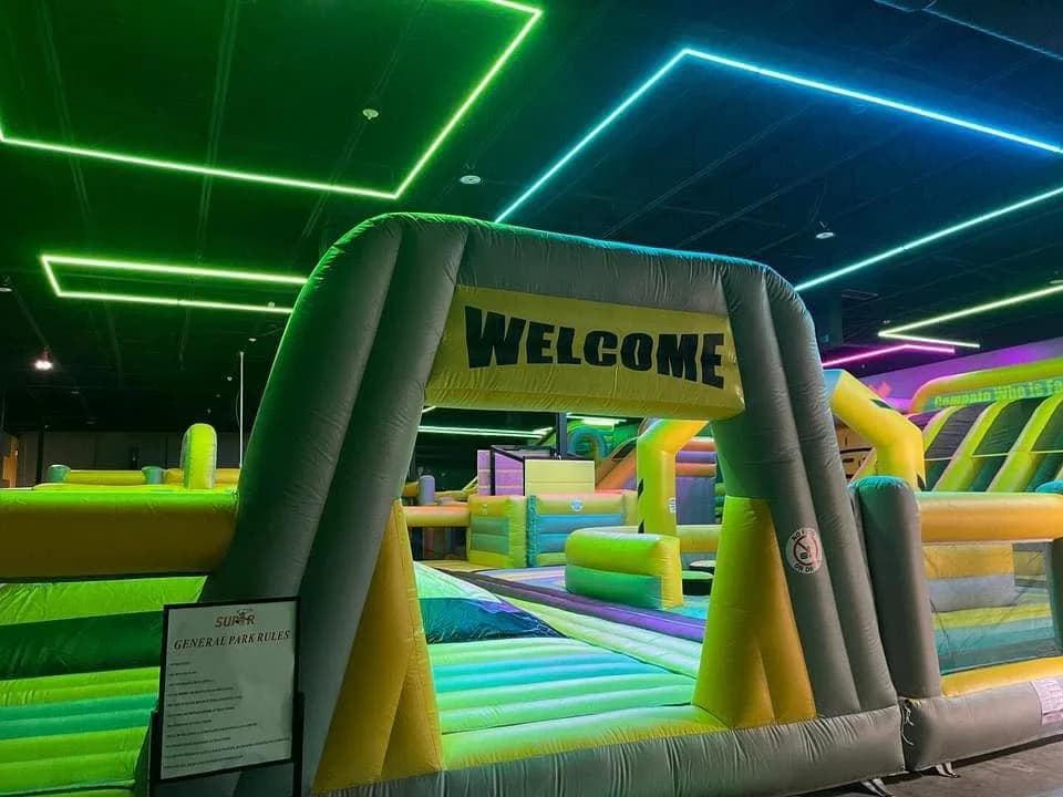 Yellow inflatable WELCOME entrance at Super Llama Plano